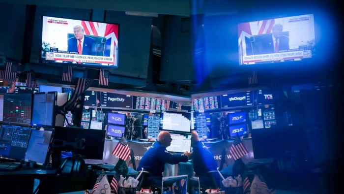 A television broadcasts US President Donald Trump on the floor of the New York Stock Exchange