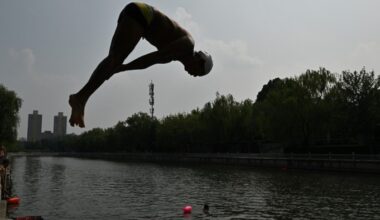 A man dives in the Longtan during a heatwave in Beijing on July 11, 2025