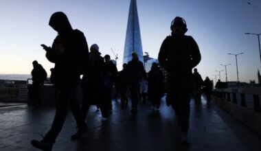 Commuters walk over London Bridge