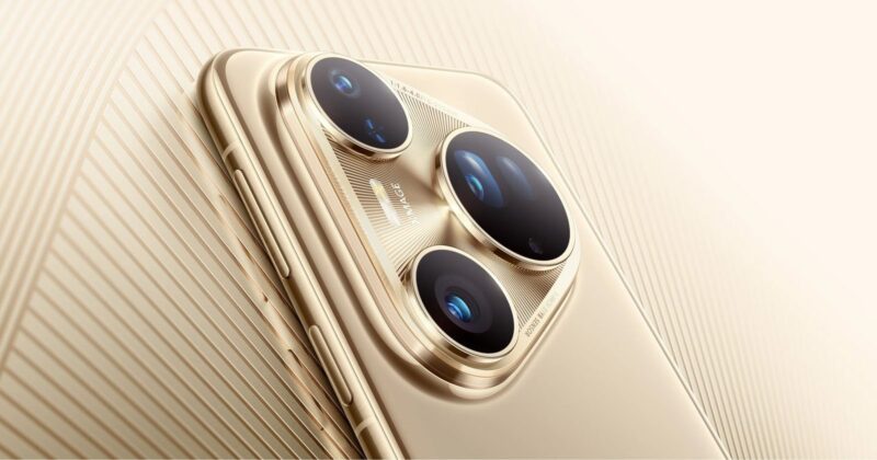 Close-up image of a gold smartphone's rear camera module, featuring three large camera lenses and a flash, set against a matching gold textured background.