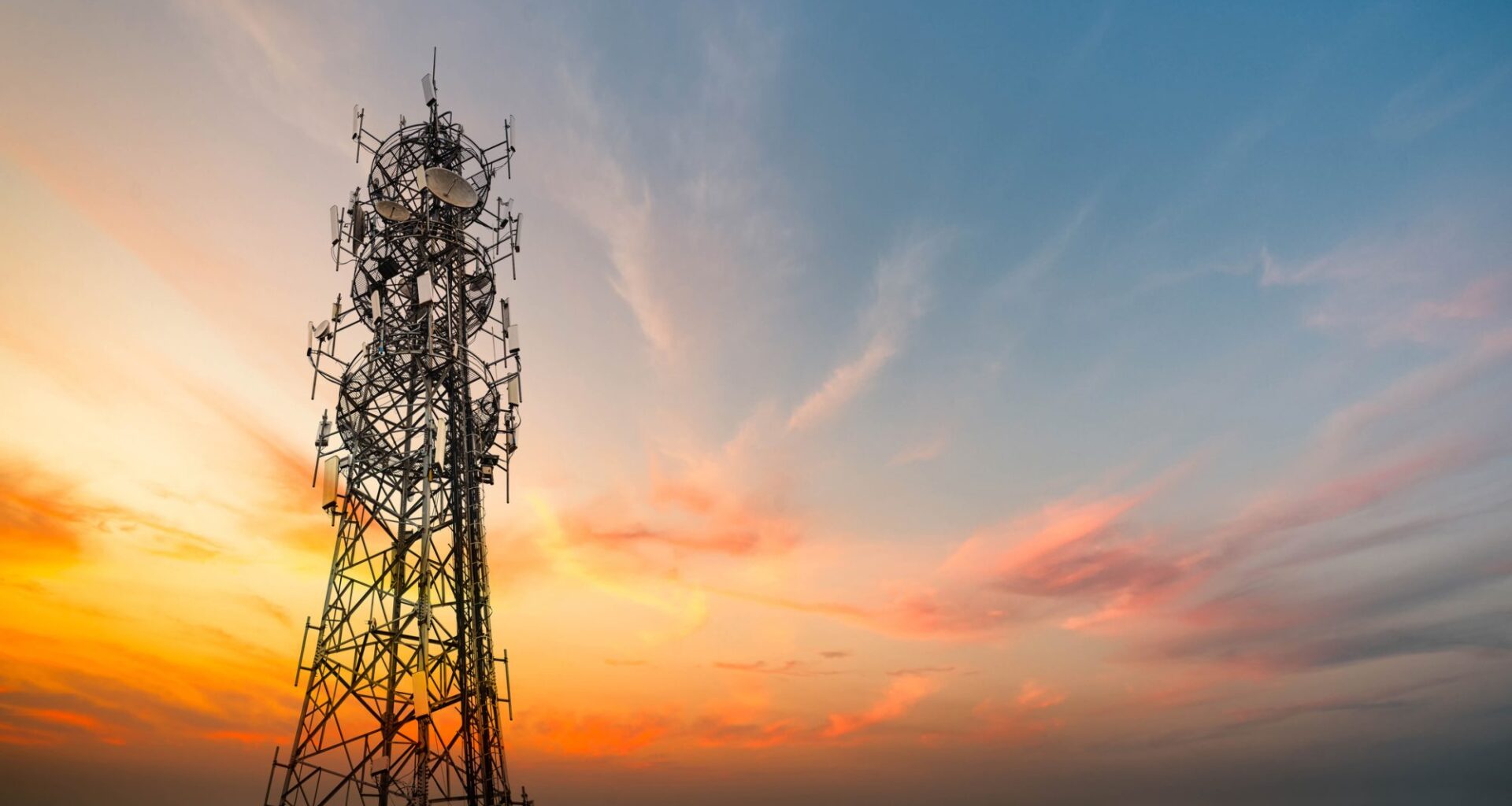 5G Sunset Cell Tower: Cellular communications tower for mobile phone and video data transmission