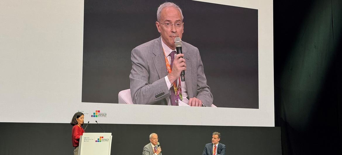 The Spanish Secretary of State for Finance Jesús Gascón (on screen) addresses a meeting at the Financing for Development conference in Sevilla, Spain.