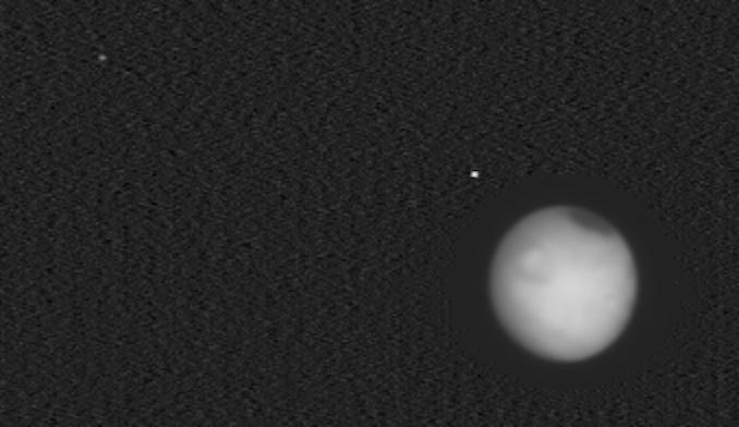Europa Clipper's view of Mars with moons Phobos and Deimos in space.