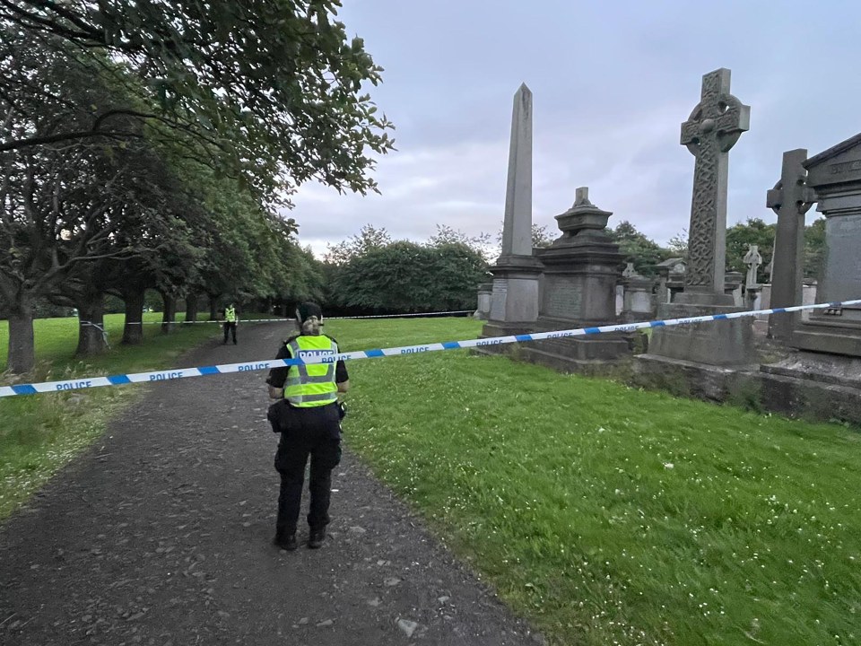 Police officer at Glasgow Necropolis crime scene.