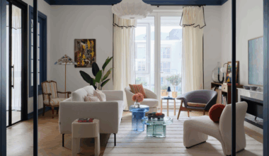 Beautiful open plan living room through an arched door way with floor to ceiling windows and contemporary furniture