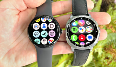 Close up of the Google Pixel Watch 3 XL next to the Samsung Galaxy Watch 8 Classic; both are in a user's hand