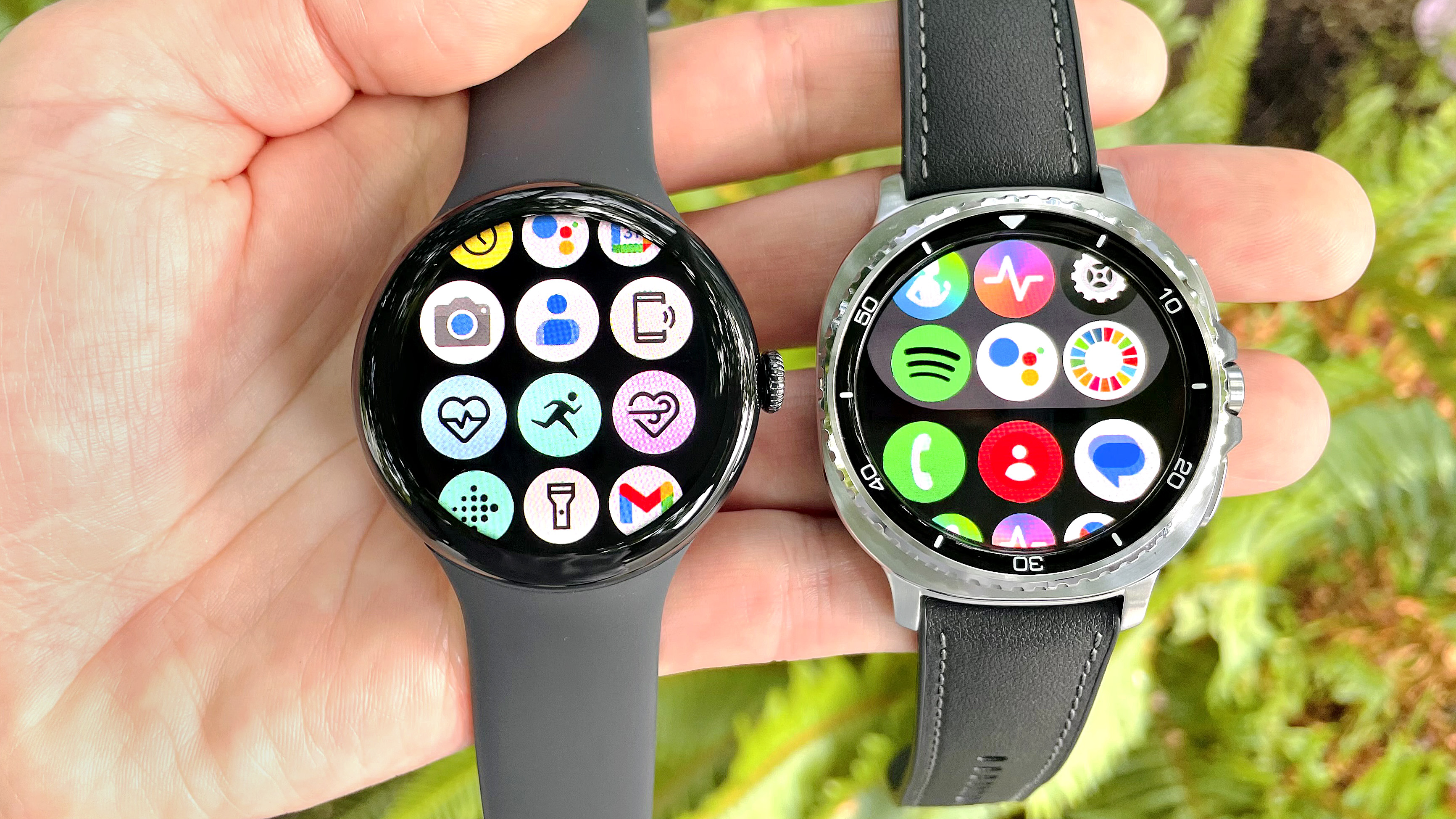 Close-up of the Google Pixel Watch 3 XL next to the Samsung Galaxy Watch 8 Classic; both are in a user's hand