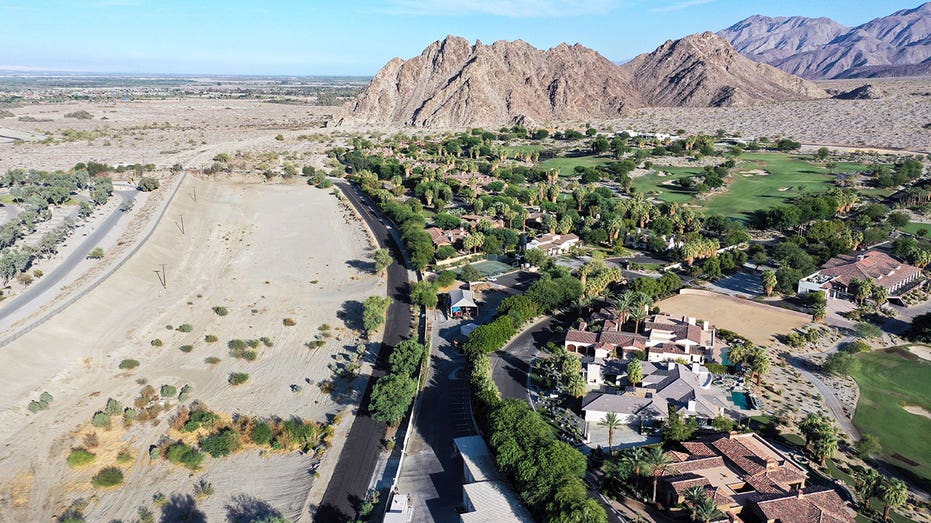 LA QUINTA, CALIFORNIA - JULY 12: An aerial view of homes and a golf course next to undeveloped desert on July 12, 2022 in La Quinta, California. According to the U.S. Drought Monitor, more than 97 percent of the state of California's land area is in at least severe drought status, with nearly 60 percent in at least extreme drought. California is now in a third consecutive year of drought amid a climate-change fueled megadrought in the Southwestern United States. (Photo by Mario Tama/Getty Images)