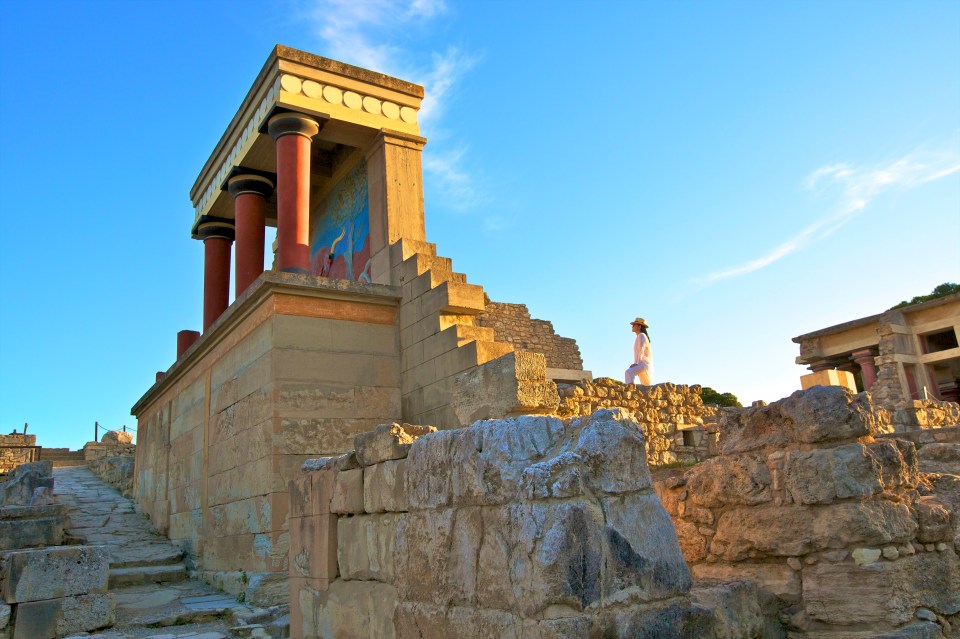 Person standing near the ruins of the Minoan Palace of Knossos.