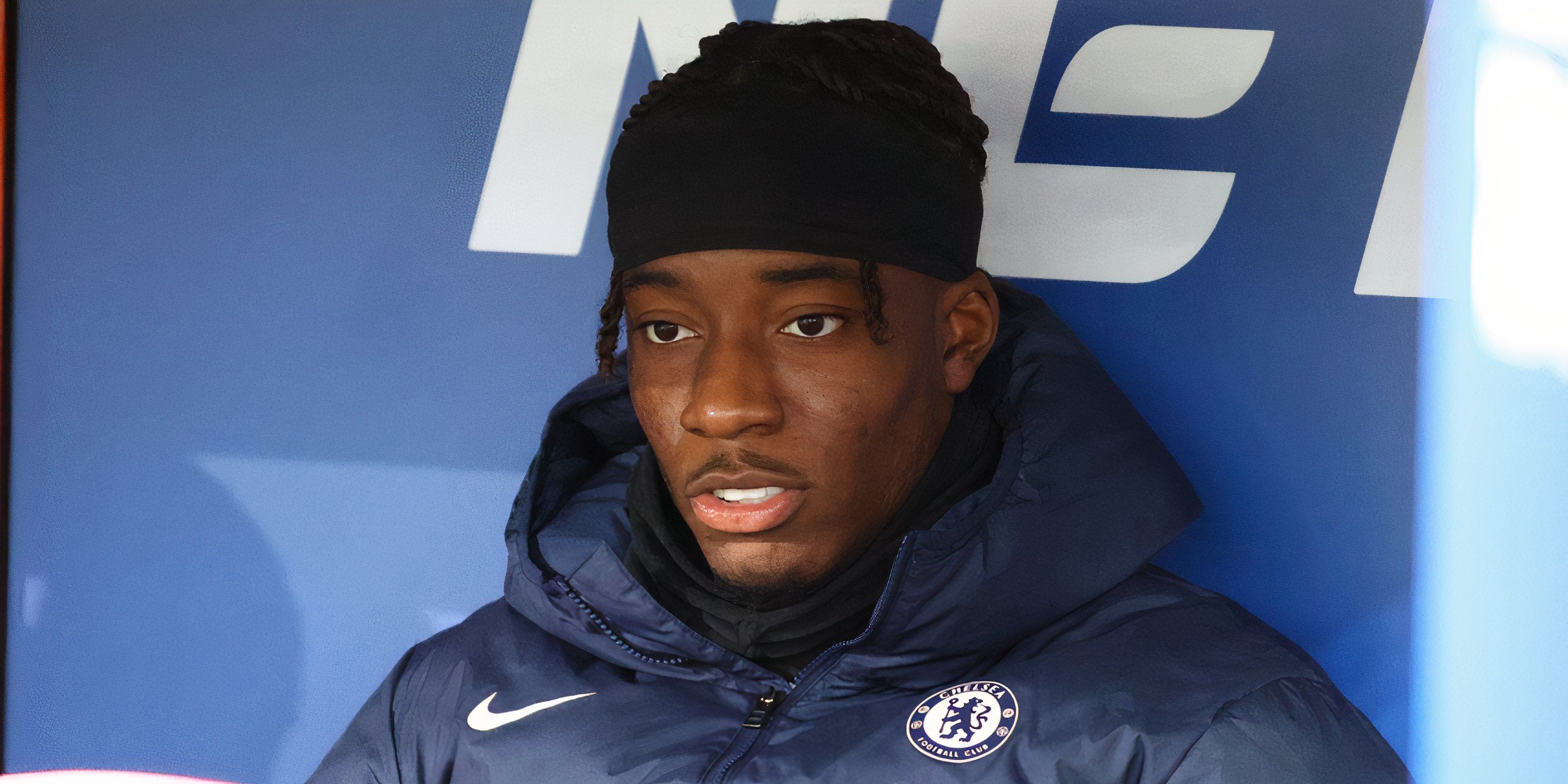 Chelsea winger Noni Madueke sitting on the bench