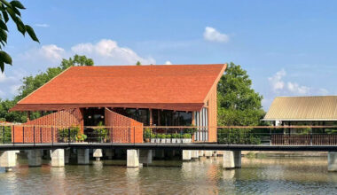 clad in terracotta tiles, morjor café by studio bewell floats above water pond in thailand