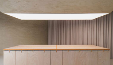 modular table reforms into exhibition platform within ceramic workshop by AACM