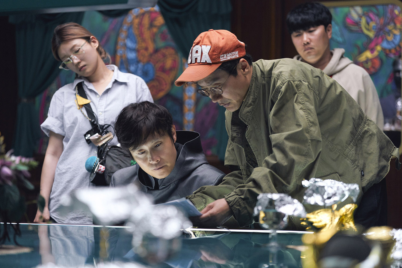Lee Byung-hun (second from left) and director Hwang Dong-hyuk (third from left) are seen on the filming set of "Squid Game" Season 3 (Netflix)