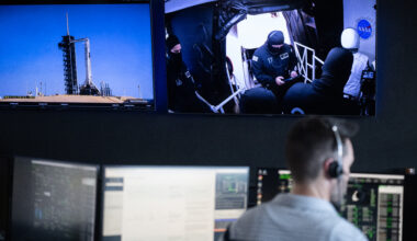 Monitors show a SpaceX Falcon 9 rocket carrying the company's Dragon spacecraft and members of the closeout crew during a dress rehearsal in preparation for the launch of NASA’s SpaceX Crew-11 mission.
