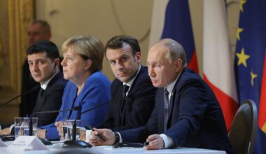Photo of Ukrainian President Volodymyr Zelensky, former German chancellor Angela Merkel, French President Emmanuel Macron, and Russian President Vladimir Putin in a Normandy Format conference.