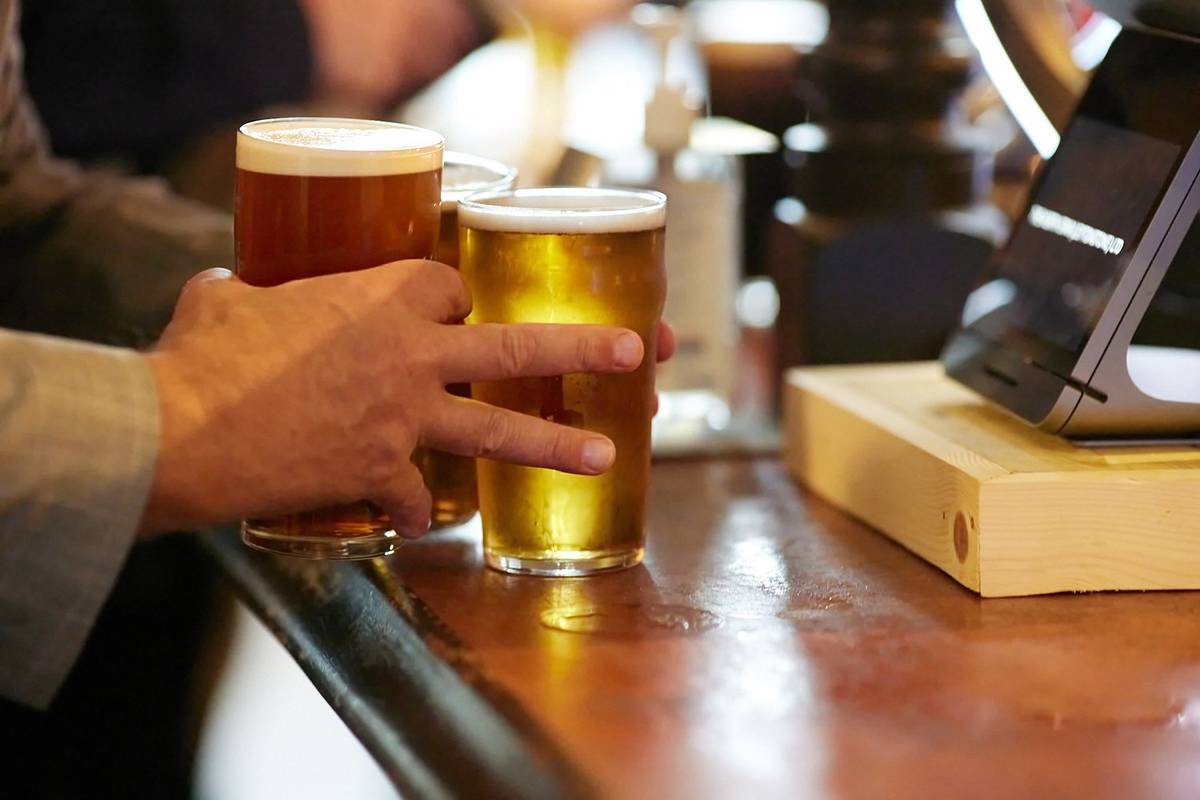 somone picking up pints from the bar at the north star pub