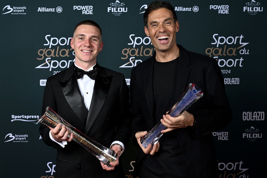 Belgian cyclist Remco Evenepoel (L) and Belgian cycling coach and former professional cyclo-cross racing cyclist Sven Vanthourenhout hold their awards during the 'Gala du Sport 2024', to announce the sportswomen and sportsmen of the Year 2024, at the Skyhall de Brussels Airport, in Zaventem on January 12, 2025. (Photo by DIRK WAEM / Belga / AFP) / Belgium OUT