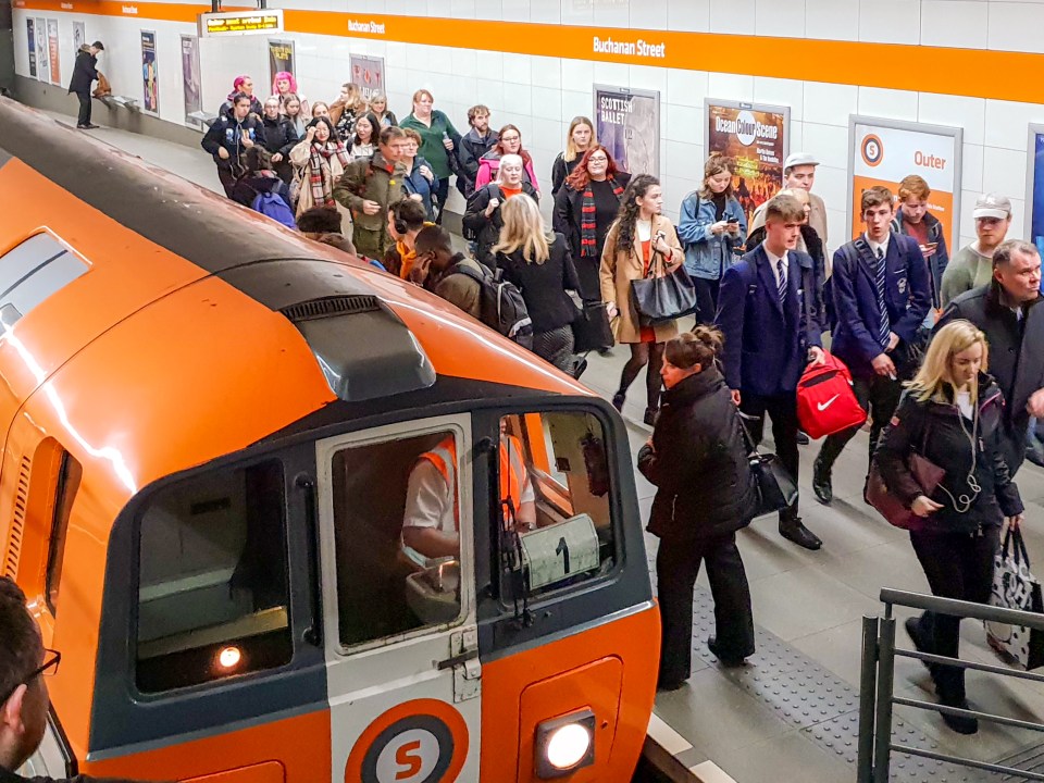 Passengers boarding a train at Buchanan Street subway station.