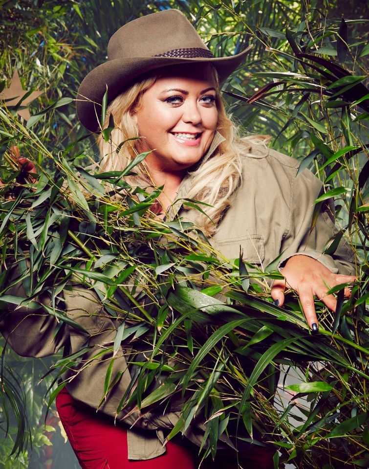 Gemma Collins in a jungle setting, holding bamboo.
