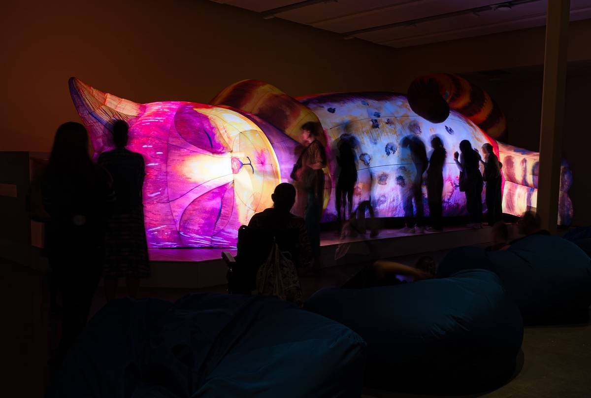 people stood by inflatable cat installation