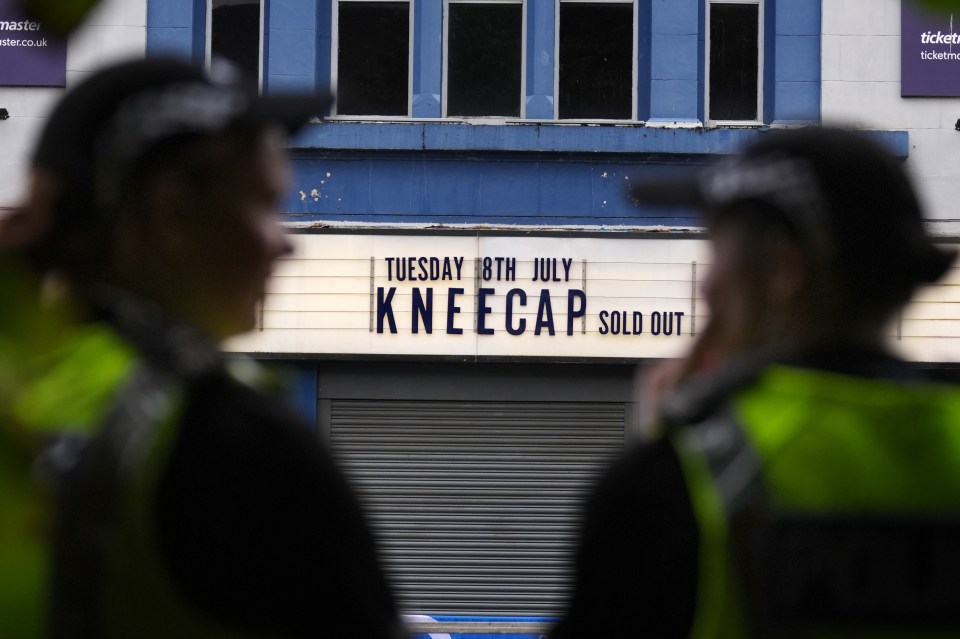 Police officers outside a sold-out Kneecap concert venue.