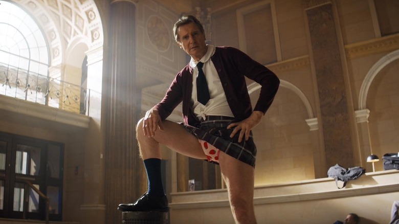 Liam Neeson as Frank Drebin Jr. iin hiis schoolgirl outfit in The Naked Gun (2025)