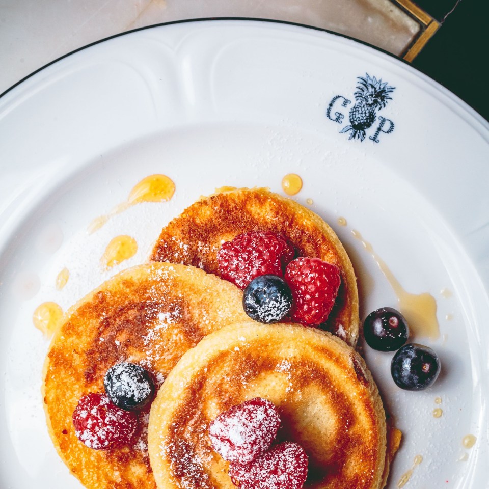 Pancakes with berries and honey.