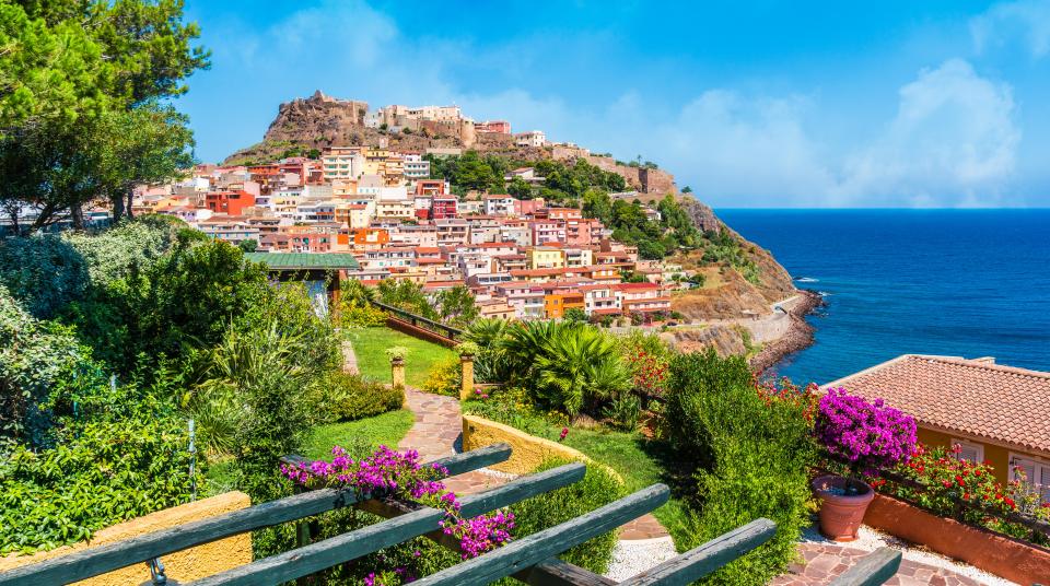 Castelsardo, Sardinia: colorful houses on a hill overlooking the sea.