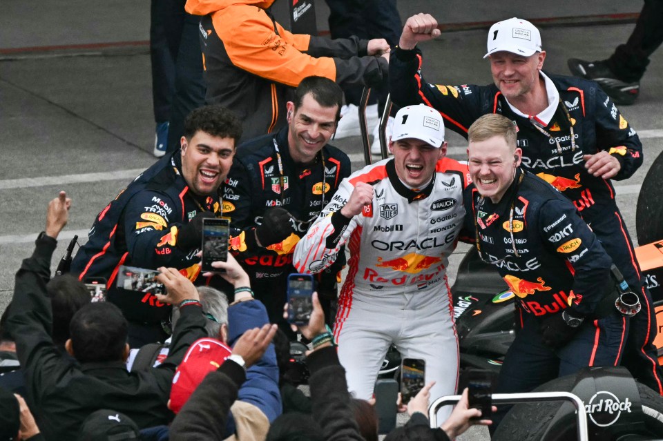 Max Verstappen and his Red Bull Racing team celebrating a Formula One victory.