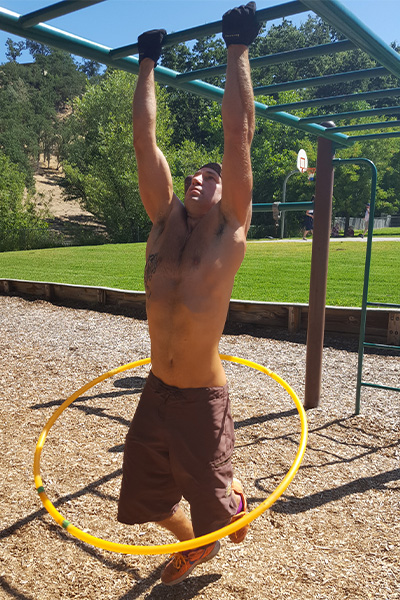 Reger hula hooping while doing chin ups