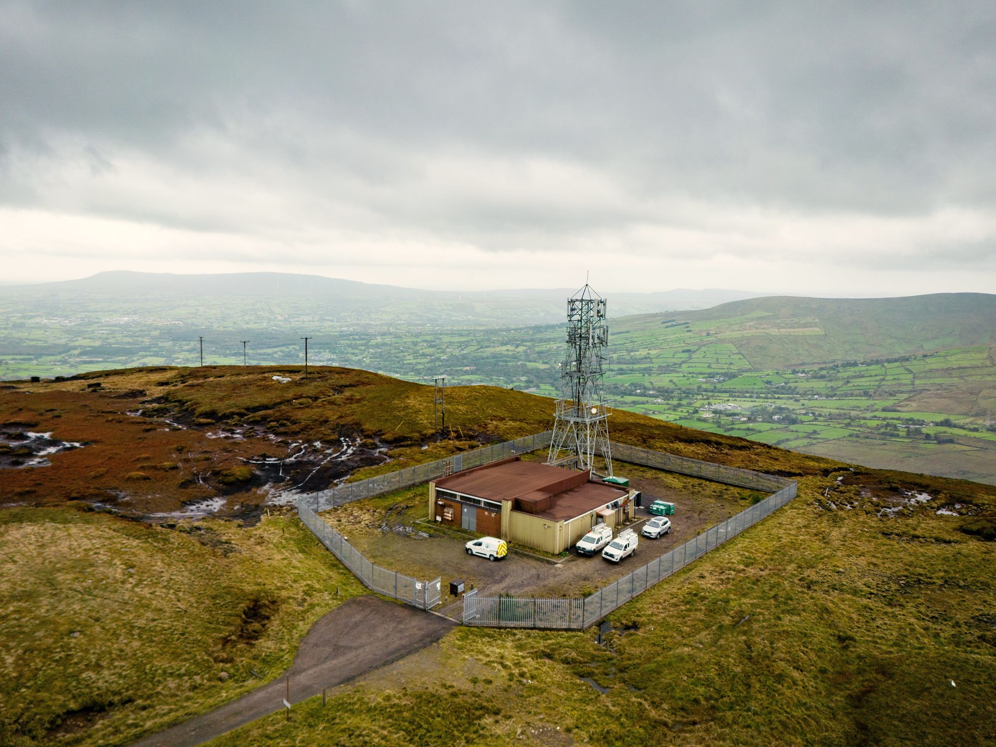 Rural mobile data mast pictured at the top of a hill in the UK