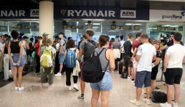 Passengers who have had flights canceled queue at the Ryanair help desk in Barcelona airport