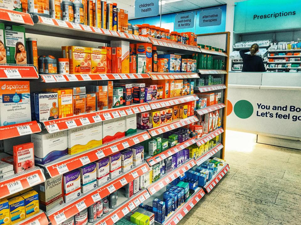 Well-stocked Boots pharmacy shelves with various over-the-counter medications.