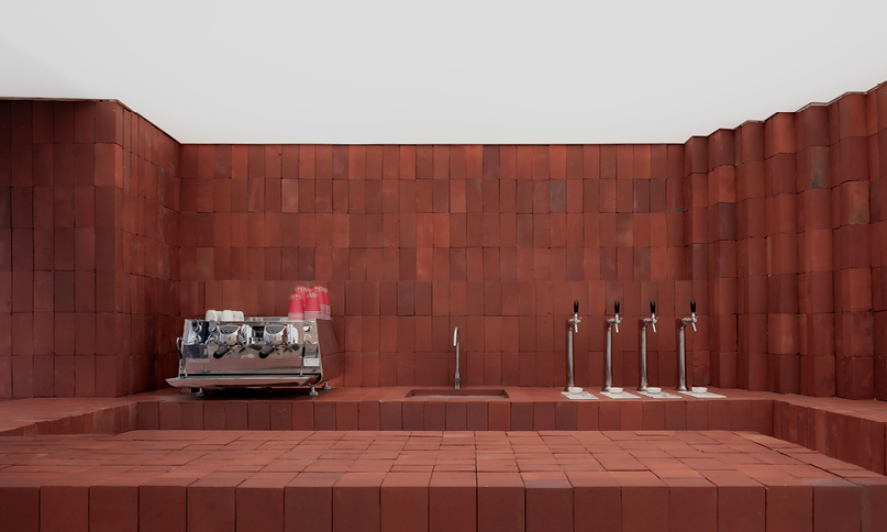 red bricks line the refreshment club's kiln-inspired flagship for parisian porcelain house 