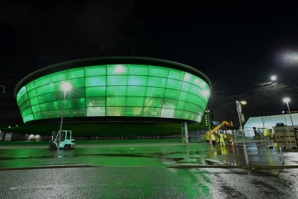 Night view of the OVO Hydro in Glasgow, Scotland, illuminated in green.