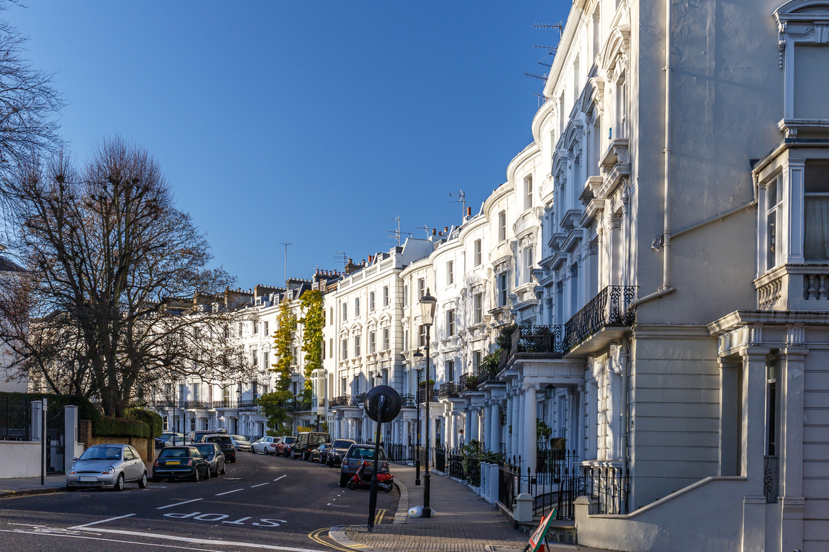 white houses along a curving road in kensington on a bright winters day