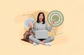 Someone with a laptop holding up money