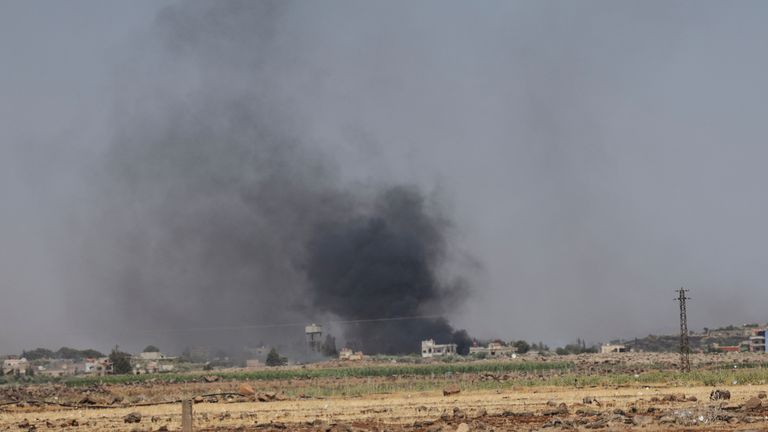Smoke rises over over Al-Mazra'a village, following renewed fighting between Bedouin and Druze , in Sweida, Syria. Pic: Reuters
