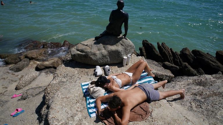 People enjoying the hot weather on Sunny Sands beach in Folkestone. Pic: PA 