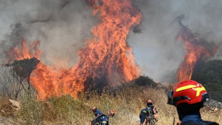 Firefighters try to extinguish flames as a wildfire burns on the island of Kythira, Greece, July 26, 2025. REUTERS/Stamatina Tamvaki
