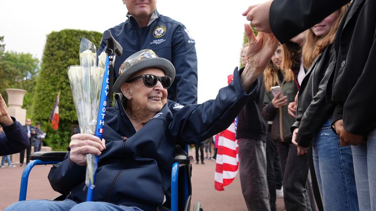 Larson greets schoolchildren during a visit in June 2025 to Colleville-sur-Mer, to the Normandy American Cemetery. Pic: AP