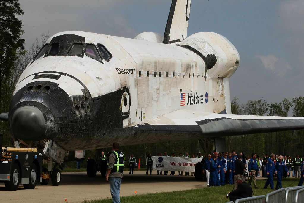 CHANTILLY, VA - APRIL 19: The Space Shuttle Discovery is towed up to an event at the Smithsonian National Air and Space Museum Steven F. Udvar-Hazy Center April 19, 2012 in Chantilly, Virginia. The space shuttle Discovery is the he oldest and most traveled vehicle from NASA's space shuttle program, and will replace the Interprise at the museum.  (Photo by Mark Wilson/Getty Images)
