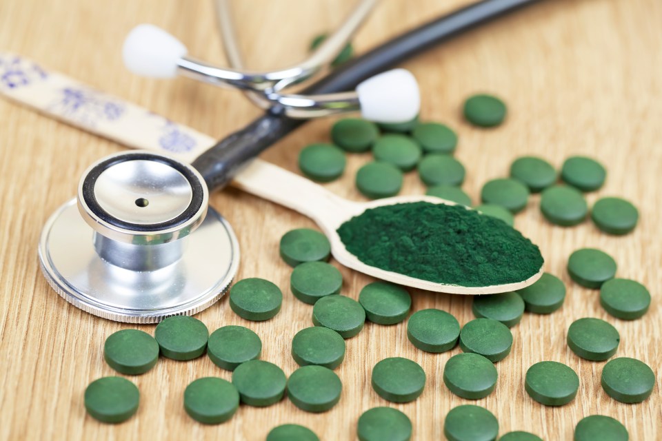 Spirulina powder and pills with a stethoscope.
