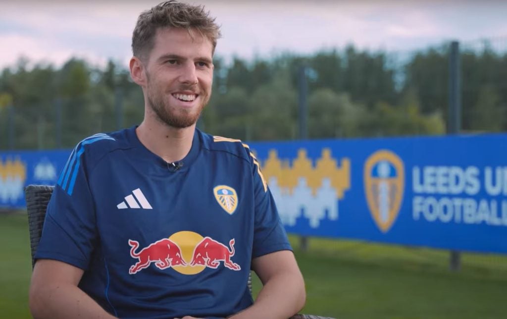 Anton Stach smiles while giving an interview as a Leeds United player.