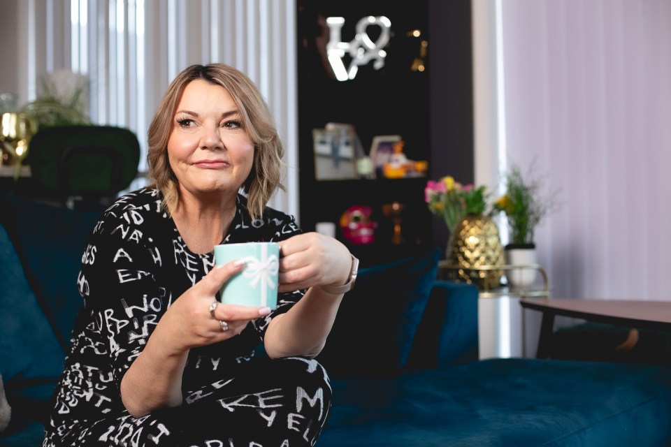 Woman sitting on a couch holding a mug.