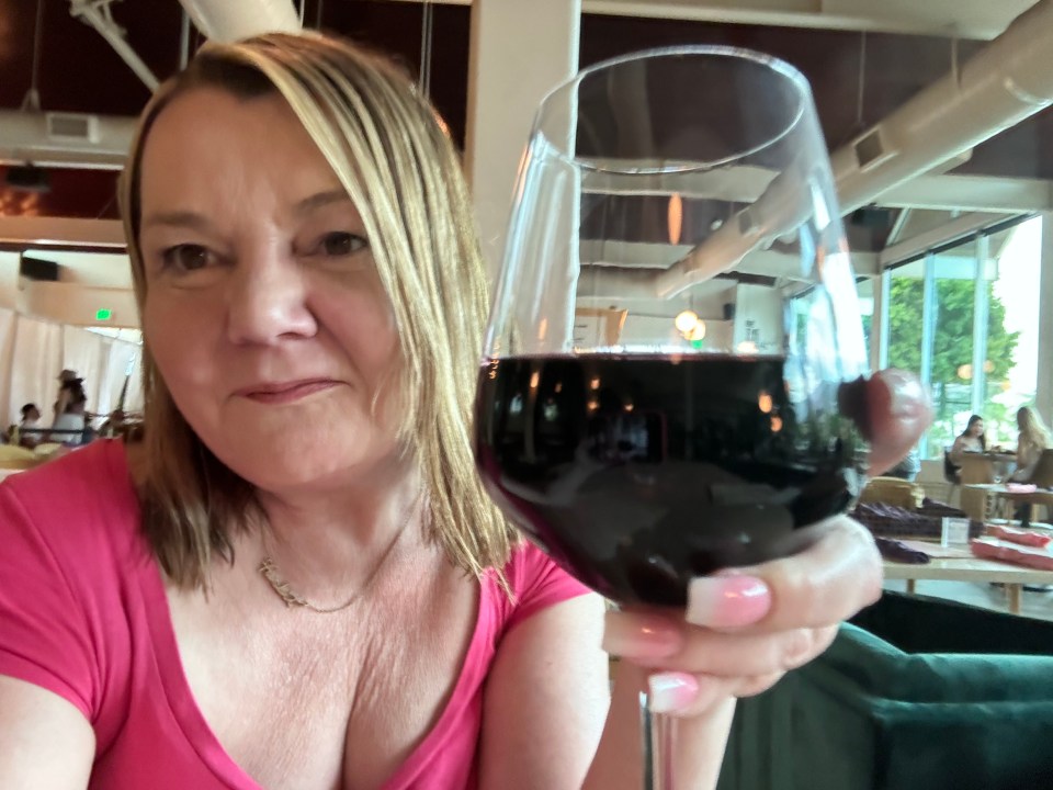 Woman holding a glass of red wine.