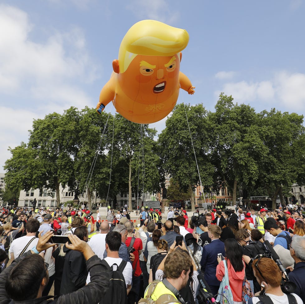 activists inflate a giant balloon depicting us president donald trump as an orange baby during a demonstration against trump's visit to the uk in parliament square in london on july 13, 2018