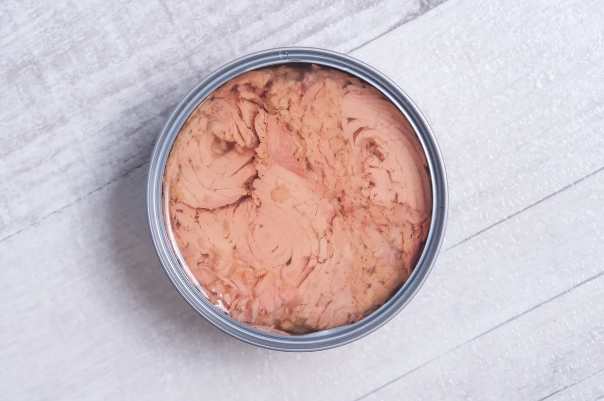 canned tuna on a wooden table