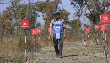 Prince Harry retraces Diana's footsteps by walking through a land mine field in Angola for charity