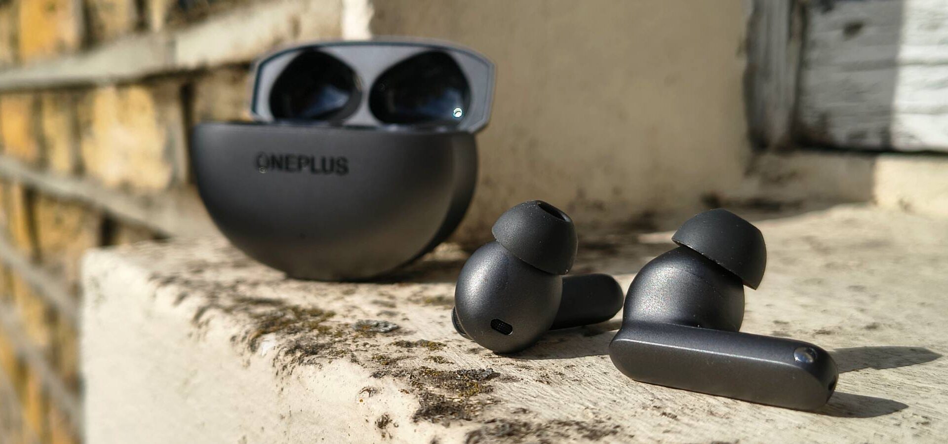 The OnePlus Buds 4 on a window sill.